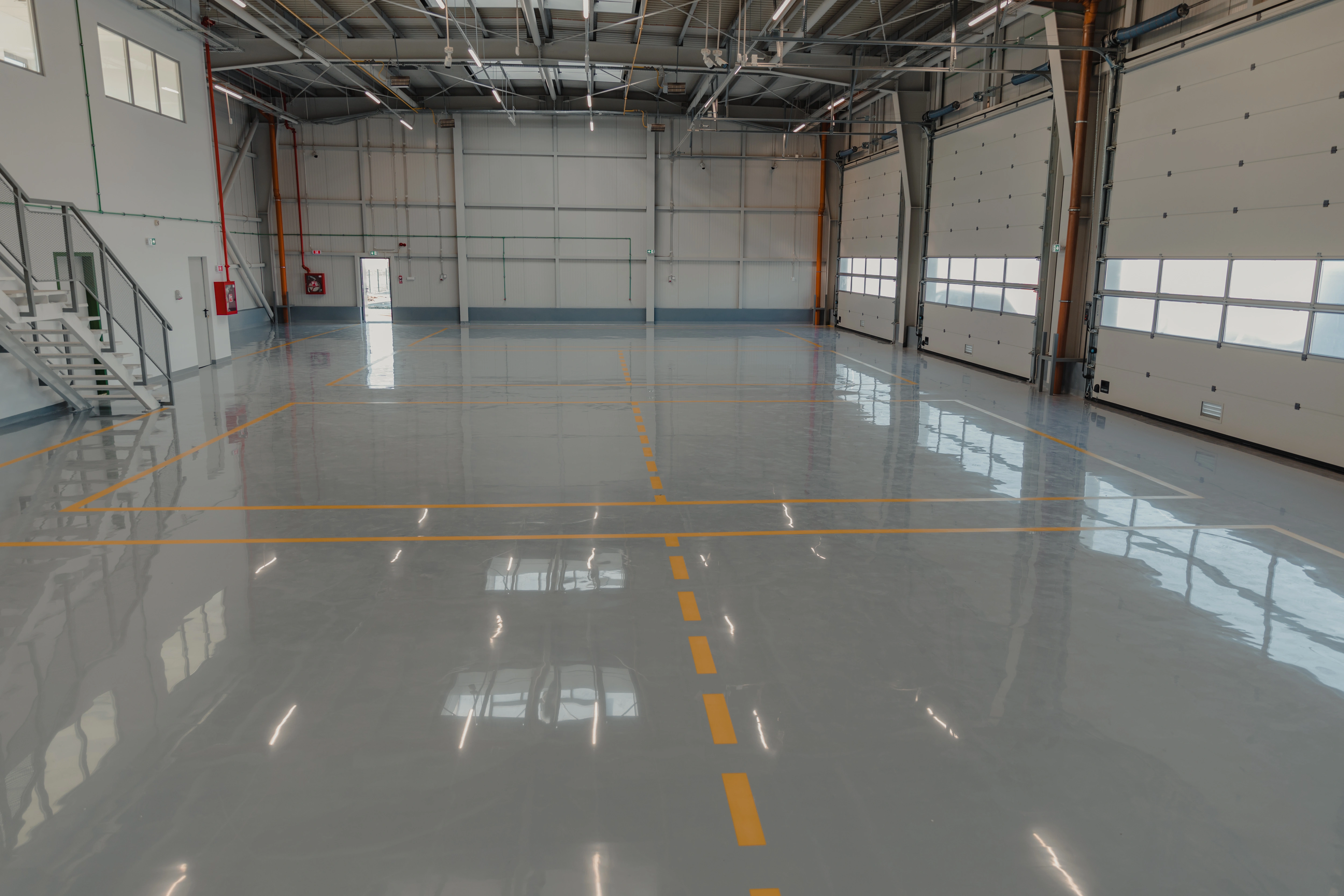Commercial epoxy floor installation Vancouver — grey solid epoxy with safety lines