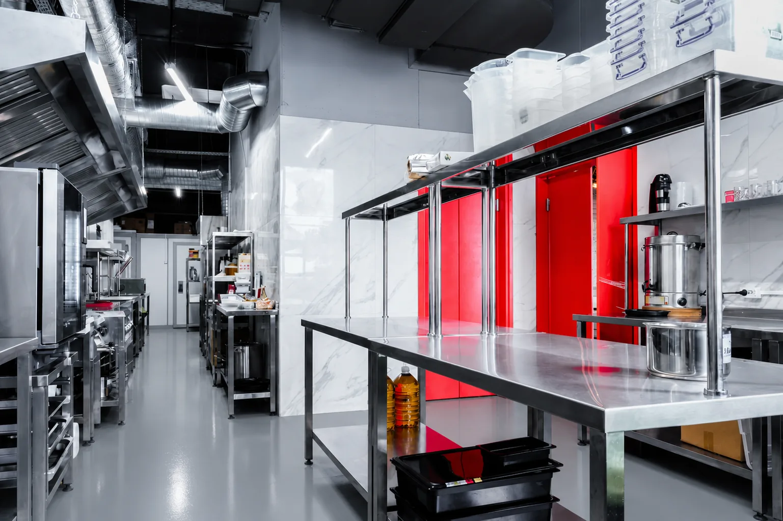 Professional commercial kitchen with seamless coated floor — stainless equipment and washdown zones in a Vancouver food service facility