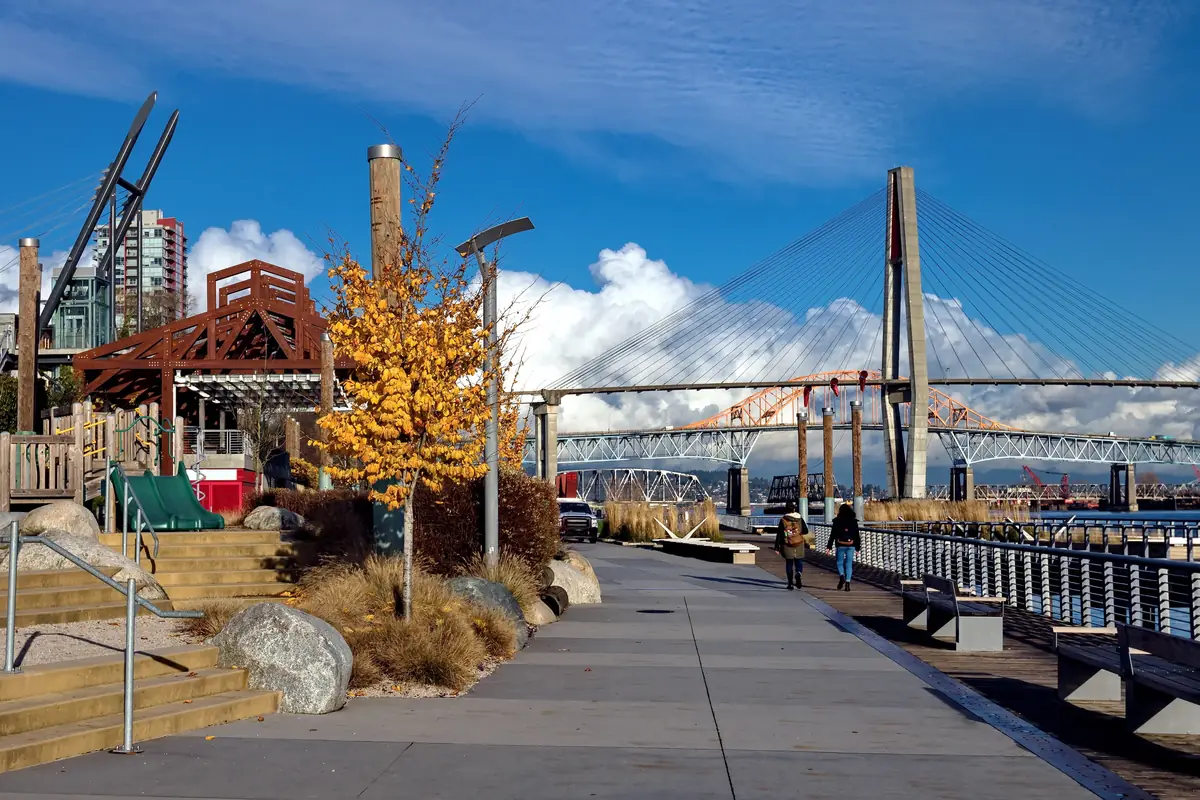 The Fraser River quay in New Westminster, BC, with the SkyTrain and Pattullo bridges