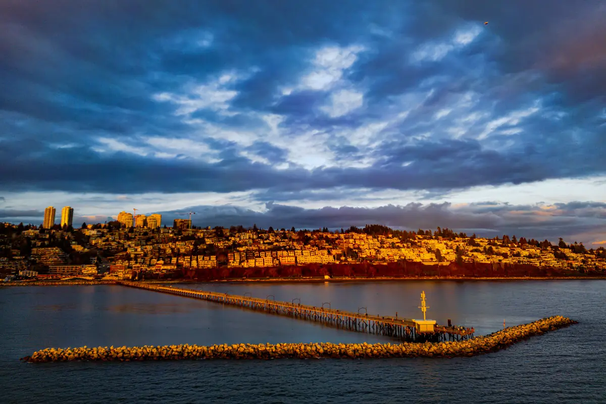 The White Rock pier and hillside homes above Semiahmoo Bay in White Rock, BC