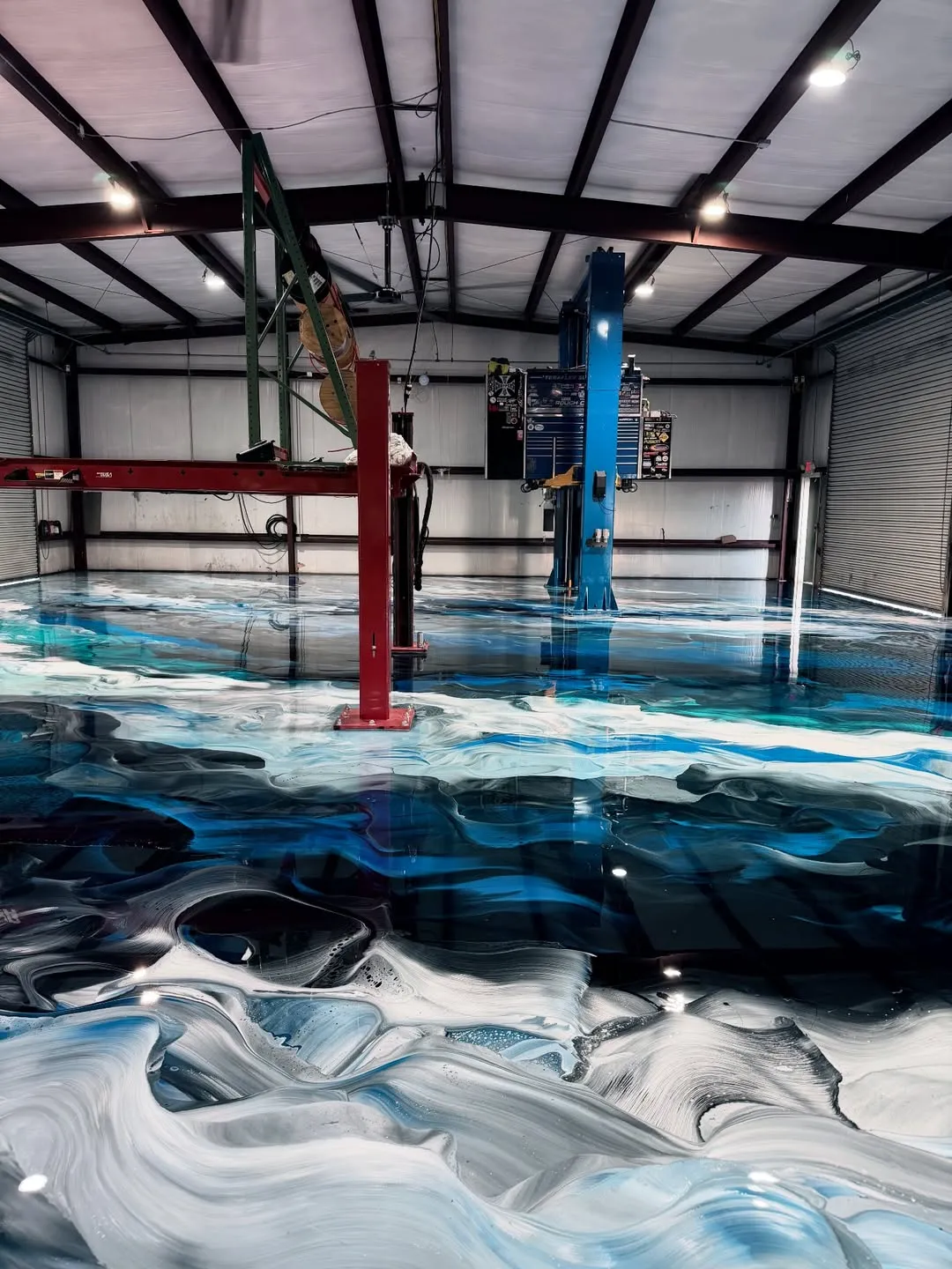 Metallic epoxy floor Vancouver — blue black ocean effect in auto shop
