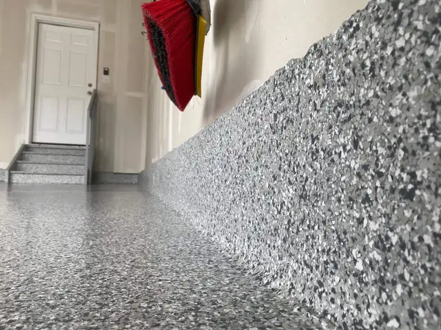 Polyaspartic flake floor coating Vancouver garage — silver grey chip finish with coved edge detail